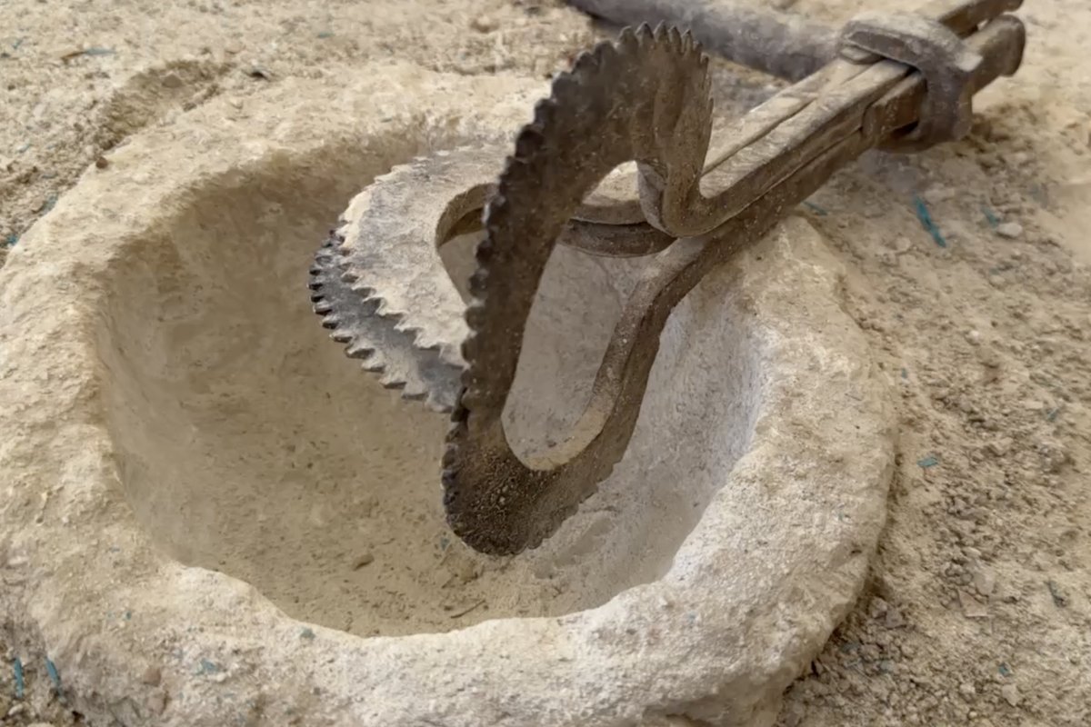 Close-up of a circular saw blade cutting into raw alabaster stone