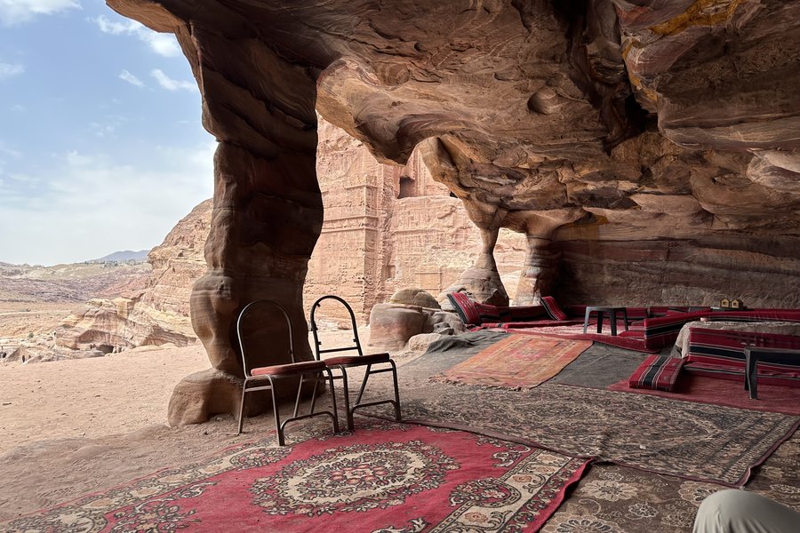 Bedouin rugs and chairs inside a sandstone cave, Petra