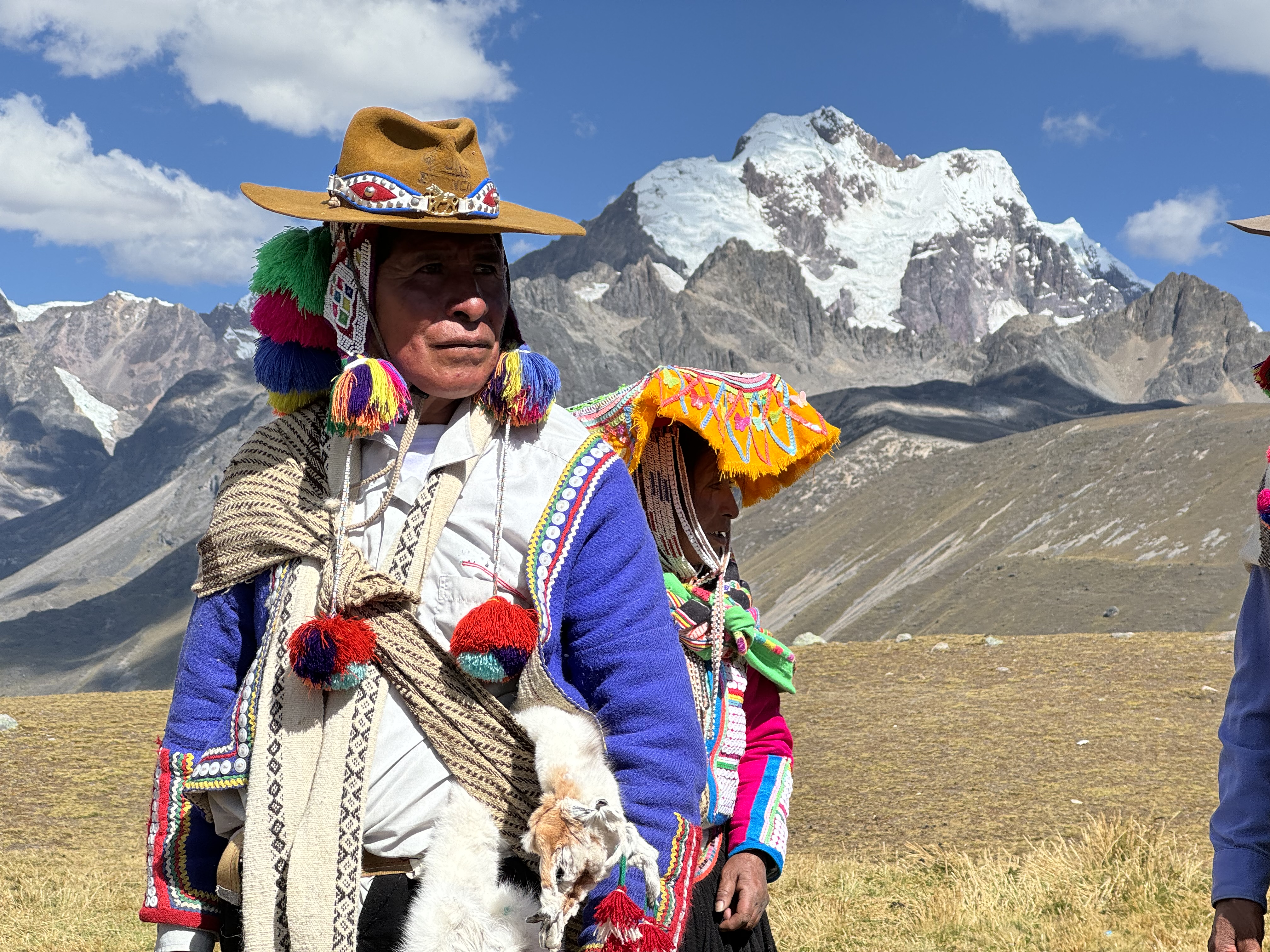 Mother carrying young child in traditional woven cloth, Andes