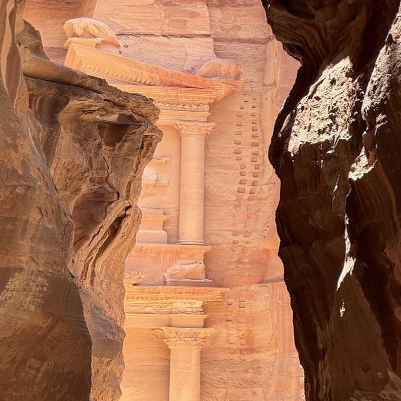 The Treasury at Petra glimpsed through the narrow Siq canyon